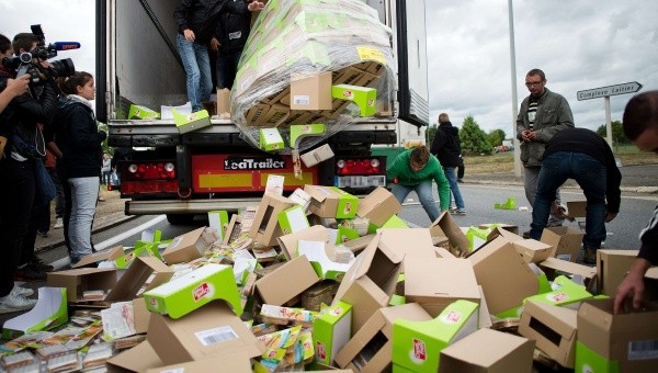 Çiftçiler, batı Fransa tarafından taşınan Laval kamyonundaki gıda paketlerni boşaltıyor. | Fotoğraf: AFP