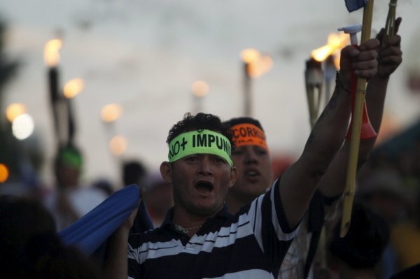 Demonstrator wearing a headband takes part in a march to demand the resignation of Honduras' President Juan Orlando Hernandez in Tegucigalpa