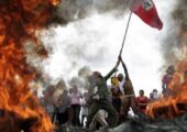 Brezilya Topraksız İşçiler Hareketi ya da MST üyeleri Brezilya karayolu üzerinde lastik yakarak bayraklarını dalgalandırıyorlar. | Fotoğraf: Reuters